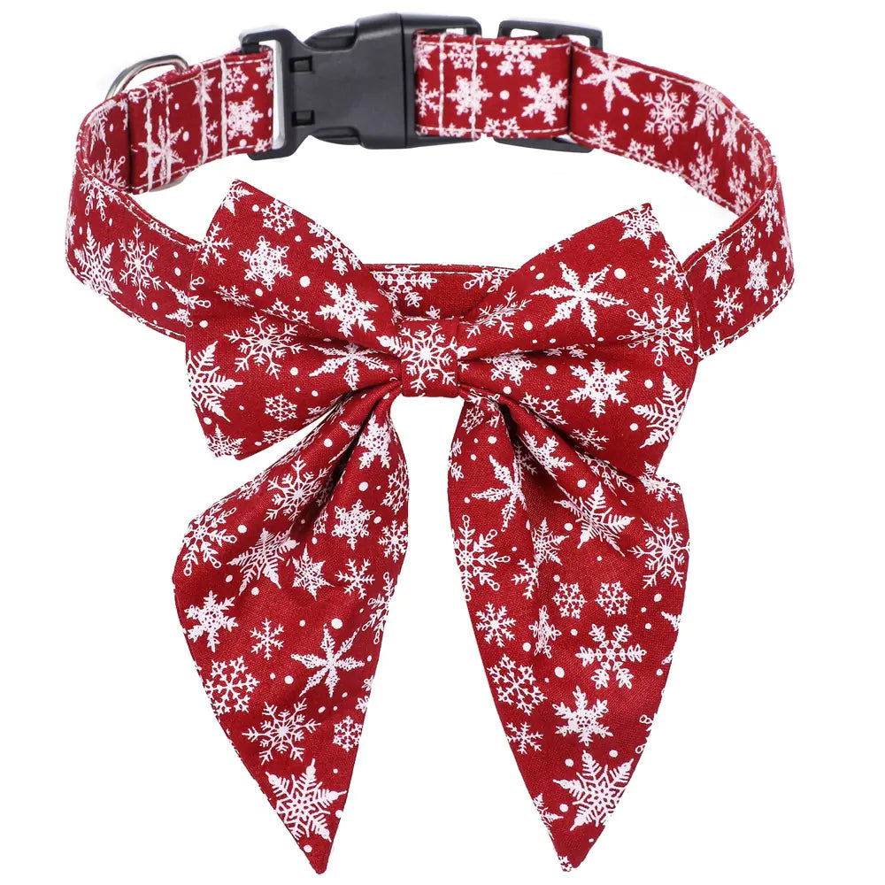 Red dog collar with white snowflake pattern and matching bow tie on a white background