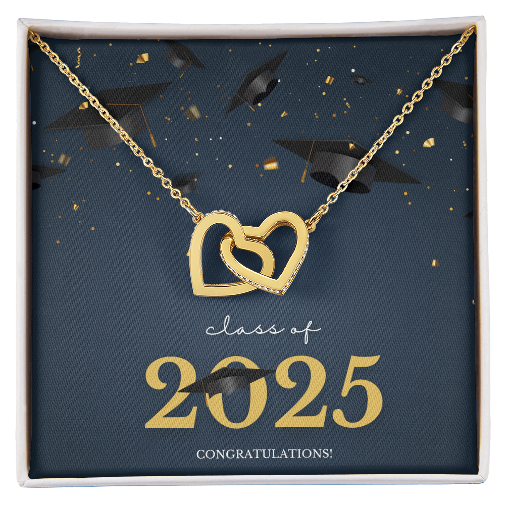 A gold interlocking hearts necklace displayed in a cherry wood box with a message card that reads "Class of 2025 – Congratulations" featuring graduation caps and celebratory confetti.