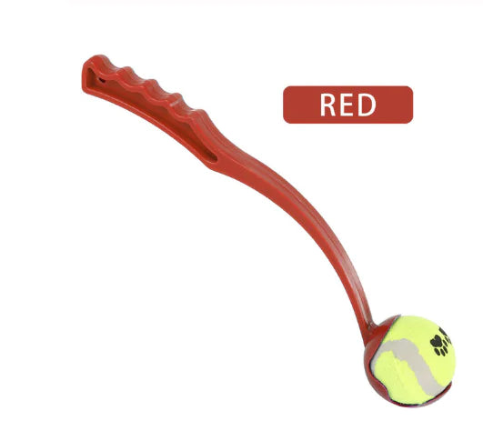 Red dog toy with a tennis ball attached on a white background