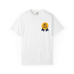 White t-shirt featuring a yellow and navy blue award ribbon graphic on the chest with the text "#1 Dad," designed as a fun and heartfelt Father's Day gift.