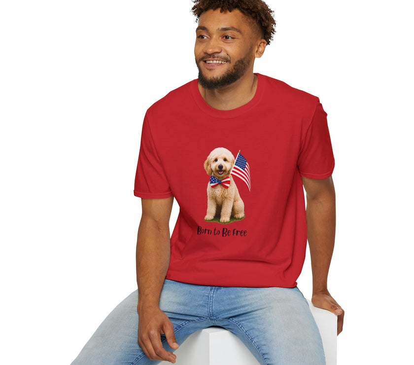 Male wearing T-shirt featuring a cute golden doodle puppy wearing an American flag bow tie and holding a small U.S. flag, with the phrase 'Born to Be Free' printed below the image.