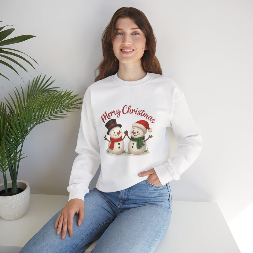 Woman wearing a white sweatshirt with Christmas-themed design sitting on a white couch.