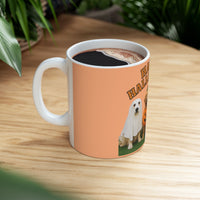 Mug with a dog design and 'Happy Halloween' text on an orange background, filled with coffee, on a wooden table.
