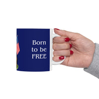 A ceramic mug featuring a Rottweiler sitting on grass, wearing a red, white, and blue bow tie, and holding an American flag against a dark blue background. with the message "Born to be Free"