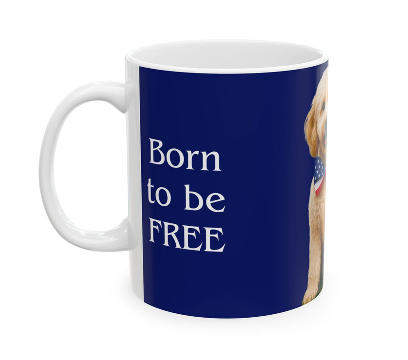 A ceramic mug featuring aGoldendoodle sitting on grass, wearing a red, white, and blue bow tie, and holding an American flag against a dark blue background. with the message "Born to be Free"  side view