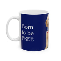 A ceramic mug featuring aGoldendoodle sitting on grass, wearing a red, white, and blue bow tie, and holding an American flag against a dark blue background. with the message "Born to be Free"  side view