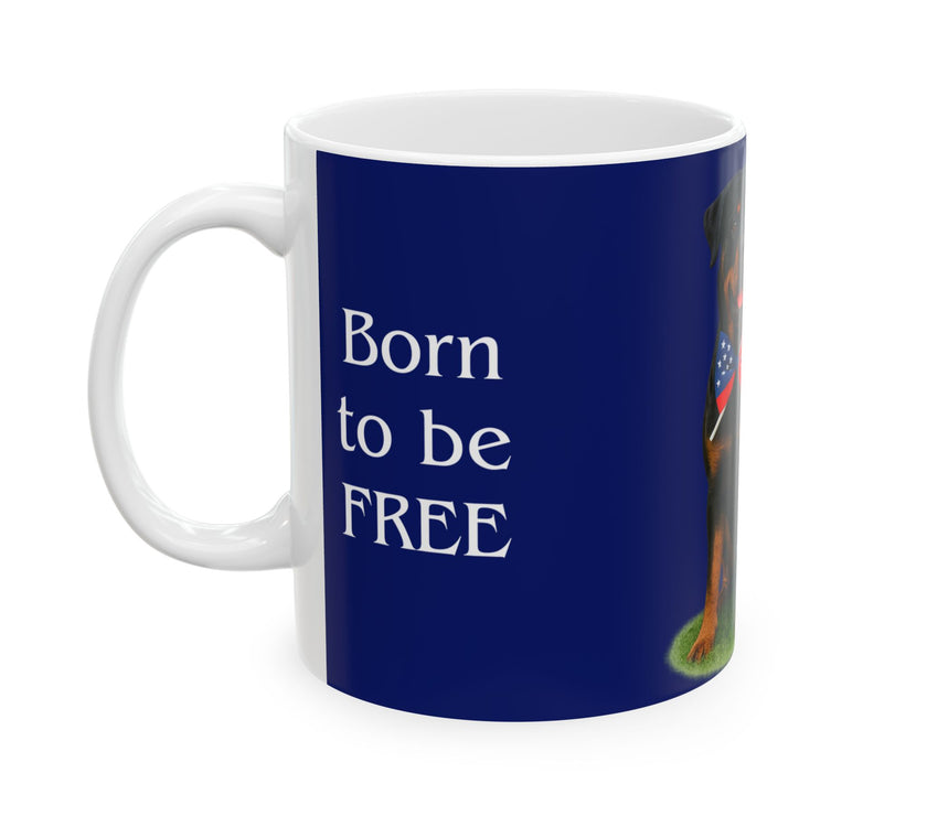 A ceramic mug featuring a Rottweiler sitting on grass, wearing a red, white, and blue bow tie, and holding an American flag against a dark blue background. with the message "Born to be Free"