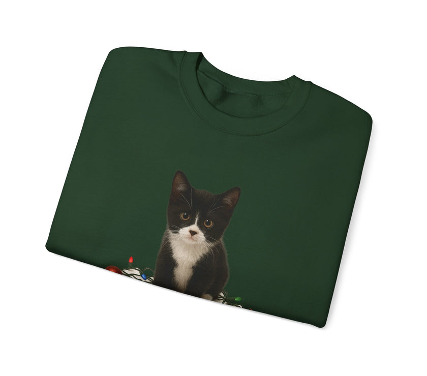 Folded green sweatshirt with a black and white cat design on a white background