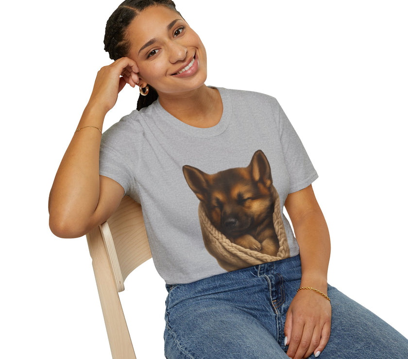 Person wearing a gray t-shirt with a dog graphic, sitting on a chair.