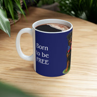 A ceramic mug featuring a Rottweiler sitting on grass, wearing a red, white, and blue bow tie, and holding an American flag against a dark blue background. with the message "Born to be Free"