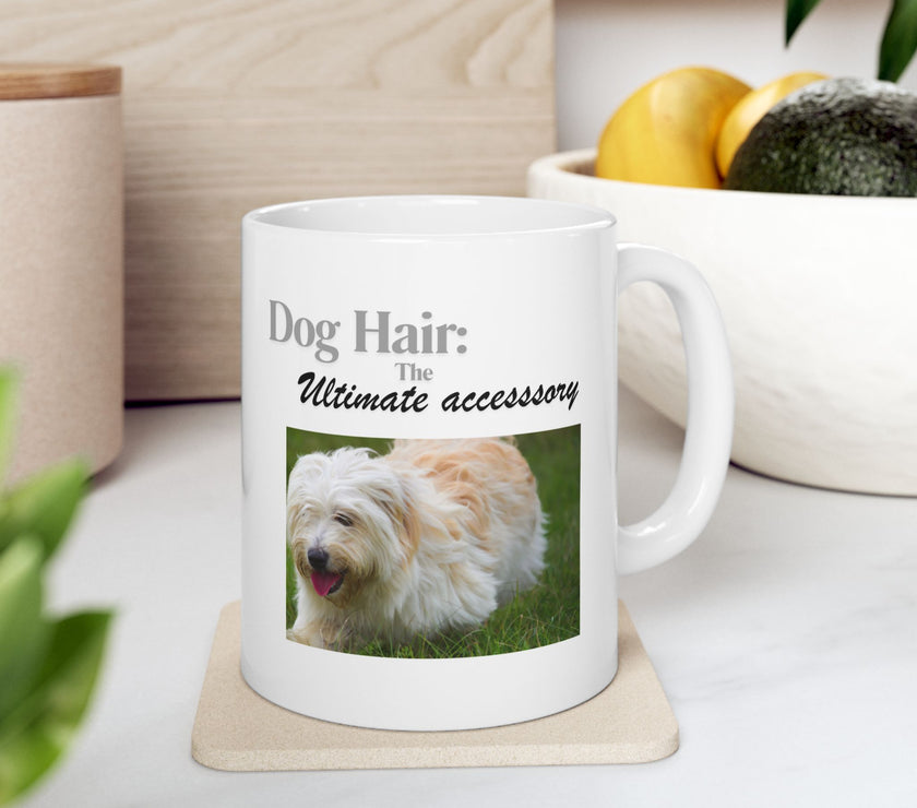 White ceramic mug featuring a photo of dogs lying on grass, with the humorous quote "Dog Hair: The Ultimate Accessory" printed below the image.