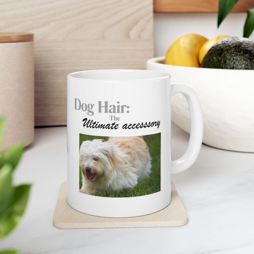 White ceramic mug featuring a photo of dogs lying on grass, with the humorous quote "Dog Hair: The Ultimate Accessory" printed below the image.
