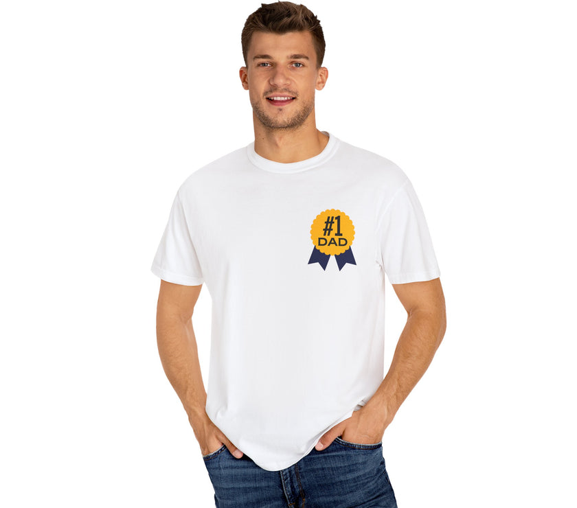 White t-shirt featuring a yellow and navy blue award ribbon graphic on the chest with the text "#1 Dad," designed as a fun and heartfelt Father's Day gift.