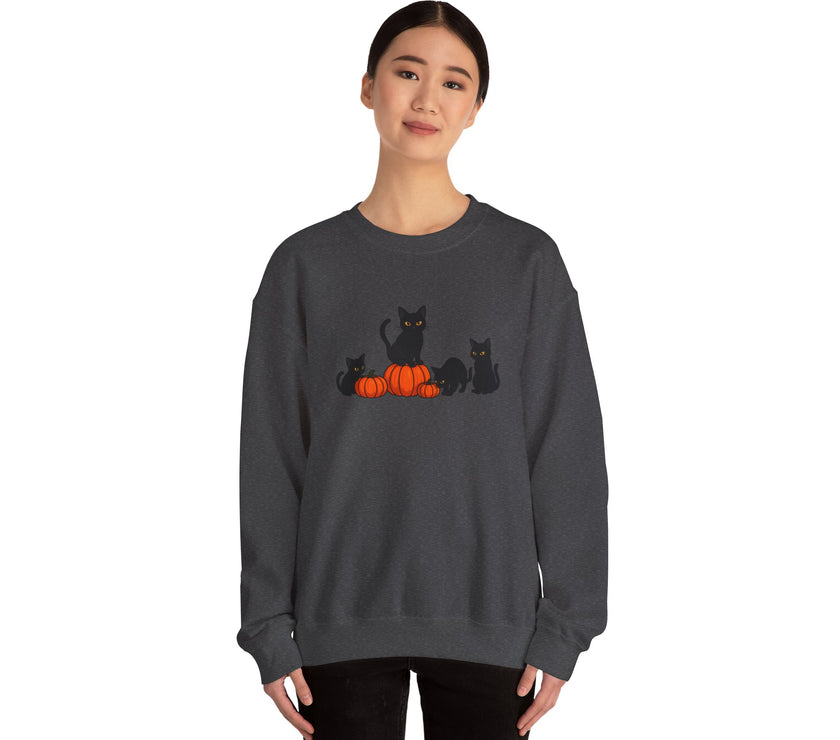 Person wearing a dark gray sweatshirt with black cats and pumpkins design on a white background