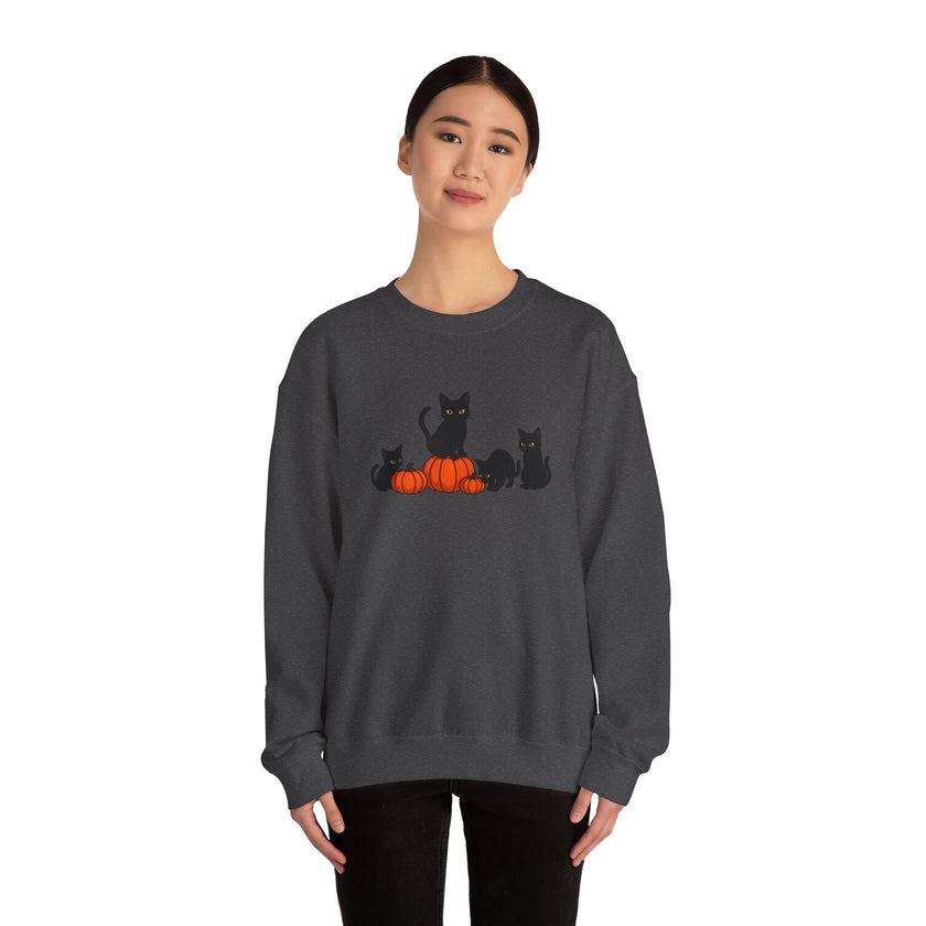 Person wearing a dark gray sweatshirt with black cats and pumpkins design on a white background