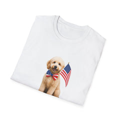 T-shirt featuring a cute golden doodle puppy wearing an American flag bow tie and holding a small U.S. flag, with the phrase 'Born to Be Free' printed below the image.  Folded T-shirt