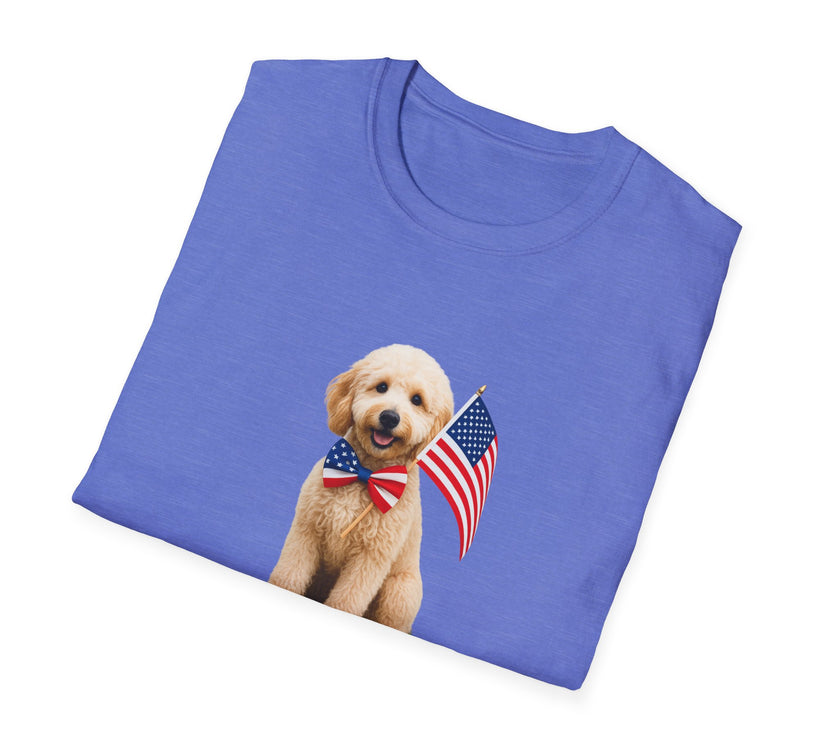 Folded T-shirt featuring a cute golden doodle puppy wearing an American flag bow tie and holding a small U.S. flag, with the phrase 'Born to Be Free' printed below the image.