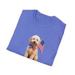 Folded T-shirt featuring a cute golden doodle puppy wearing an American flag bow tie and holding a small U.S. flag, with the phrase 'Born to Be Free' printed below the image.