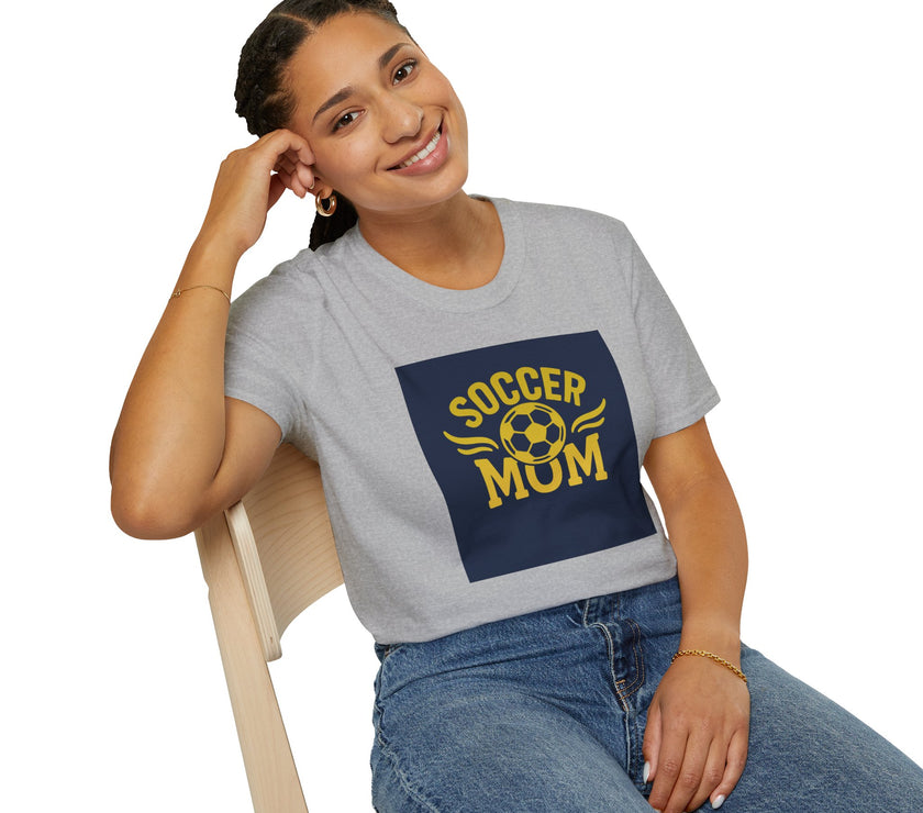 Woman wearing a gray t-shirt with 'Soccer Mum' design, sitting on a chair.