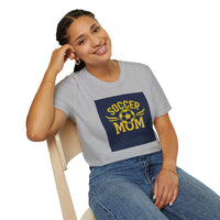 Woman wearing a gray t-shirt with 'Soccer Mum' design, sitting on a chair.