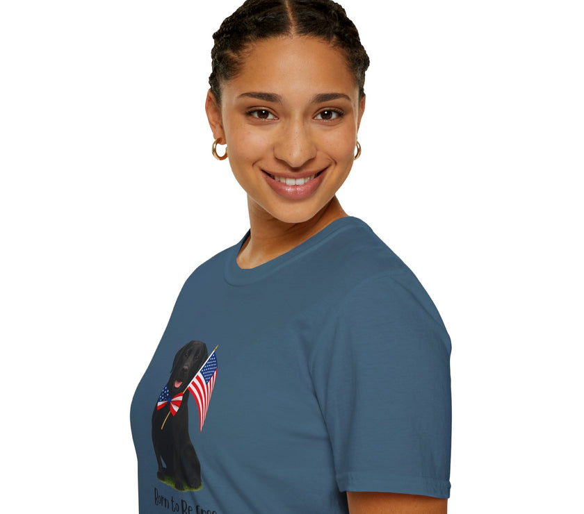 Indigo Blue t-shirt featuring a patriotic Black Lab wearing an American flag bowtie and holding U.S. flags, with the Black Lab phrase "Born to Be Free" printed below — perfect for dog lovers and patriotic Americans.
