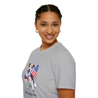 Female wearing T-shirt featuring a cute  puppy wearing an American flag bow tie and holding a small U.S. flag, with the phrase 'Born to Be Free' printed below the image.