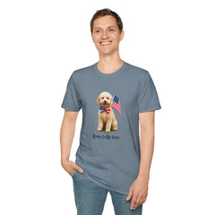 Male wearing T-shirt featuring a cute golden doodle puppy wearing an American flag bow tie and holding a small U.S. flag, with the phrase 'Born to Be Free' printed below the image.