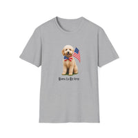 T-shirt featuring a cute golden doodle puppy wearing an American flag bow tie and holding a small U.S. flag, with the phrase 'Born to Be Free' printed below the image.