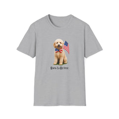 T-shirt featuring a cute golden doodle puppy wearing an American flag bow tie and holding a small U.S. flag, with the phrase 'Born to Be Free' printed below the image.