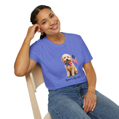 Female wearing T-shirt featuring a cute golden doodle puppy wearing an American flag bow tie and holding a small U.S. flag, with the phrase 'Born to Be Free' printed below the image.