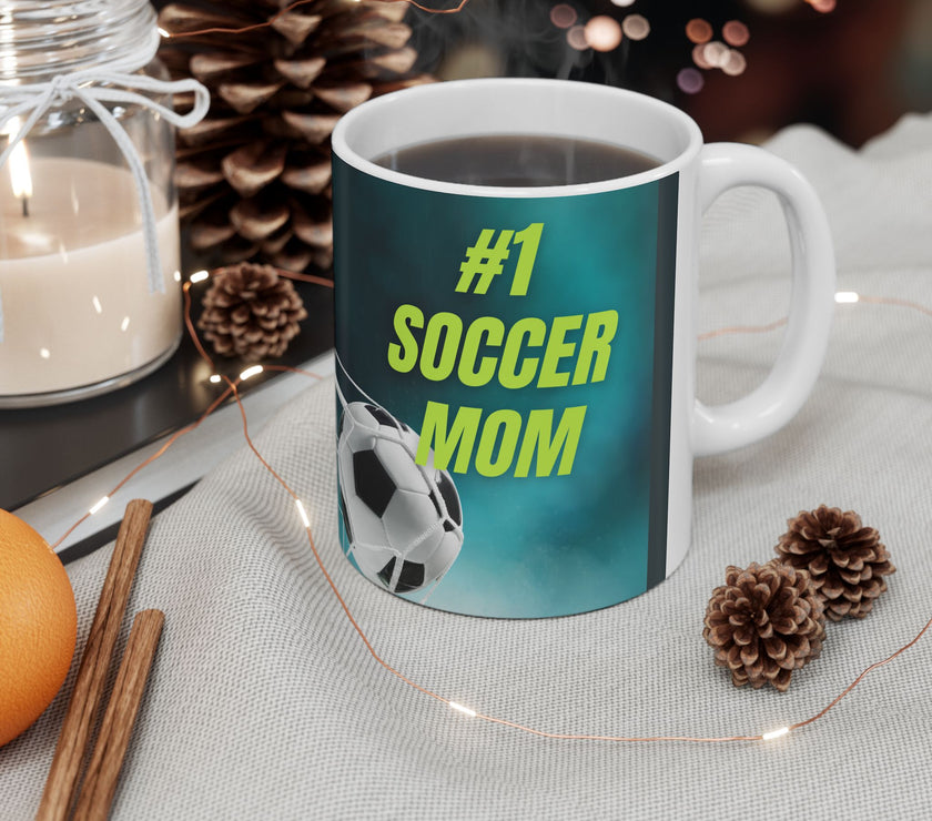 Mug with '#1 Soccer Mom' text and soccer ball design on a teal background