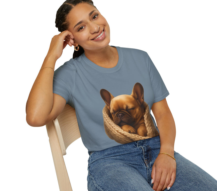 Person wearing a blue t-shirt with a dog graphic, sitting on a chair.