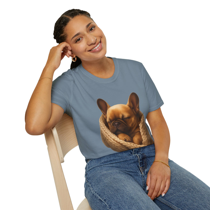 Person wearing a blue t-shirt with a dog graphic, sitting on a chair.
