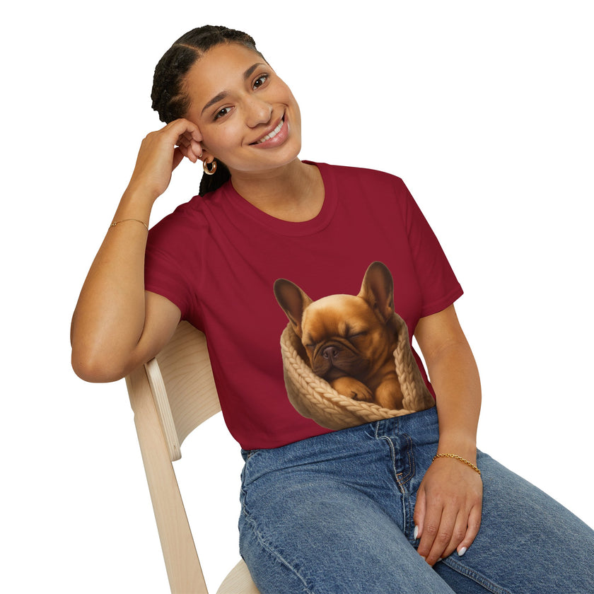 Person wearing a red t-shirt with a dog graphic, sitting on a chair.