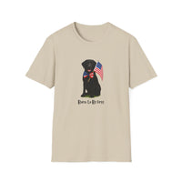 Sand t-shirt featuring a patriotic Black Lab wearing an American flag bowtie and holding U.S. flags, with the Black Labphrase "Born to Be Free" printed below — perfect for dog lovers and patriotic Americans.