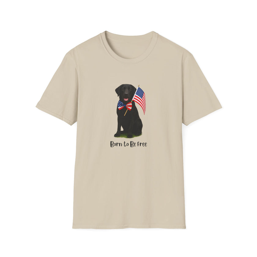 Sand t-shirt featuring a patriotic Black Lab wearing an American flag bowtie and holding U.S. flags, with the Black Labphrase "Born to Be Free" printed below — perfect for dog lovers and patriotic Americans.