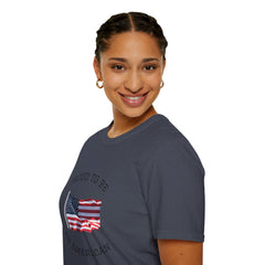 Smiling woman  wearing a white t-shirt with an American flag graphic and the words 'Proud to Be an American' printed around the flag