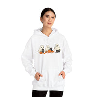 Person wearing a white hoodie with Halloween-themed design on a white background