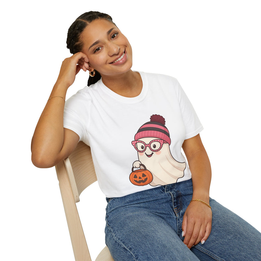 Person wearing a white t-shirt with a ghost graphic design, sitting on a chair against a white background.