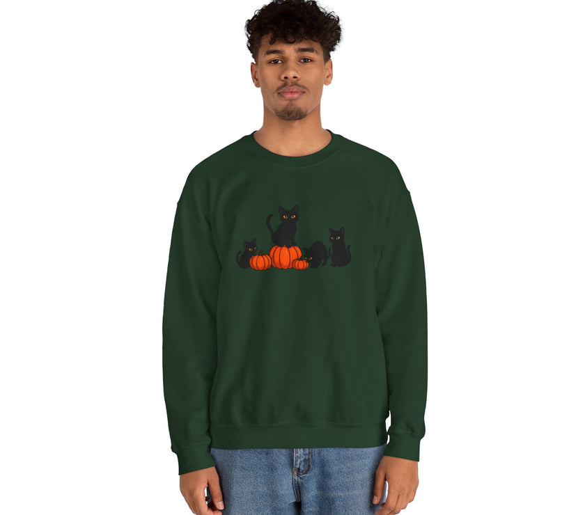Person wearing a green sweatshirt with black cats and pumpkins design on a white background