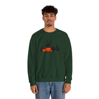 Person wearing a green sweatshirt with black cats and pumpkins design on a white background