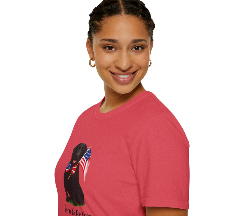 Heather Red  t-shirt featuring a patriotic Black Lab wearing an American flag bowtie and holding U.S. flags, with the Black Lab phrase "Born to Be Free" printed below — perfect for dog lovers and patriotic Americans.