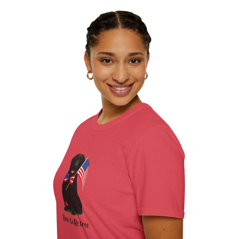 Heather Red  t-shirt featuring a patriotic Black Lab wearing an American flag bowtie and holding U.S. flags, with the Black Lab phrase "Born to Be Free" printed below — perfect for dog lovers and patriotic Americans.