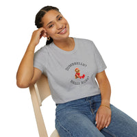 Person wearing a gray t-shirt with a graphic and text, sitting on a chair.