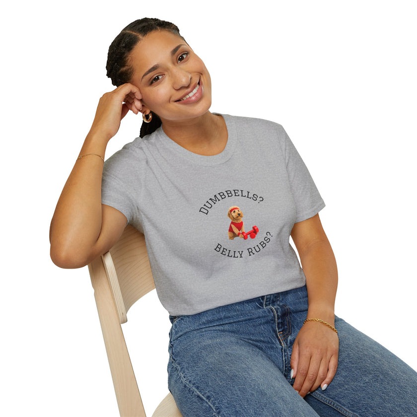 Person wearing a gray t-shirt with a graphic and text, sitting on a chair.