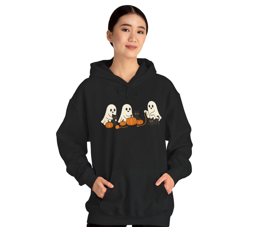 Person wearing a black hoodie with Halloween-themed ghost design on a white background