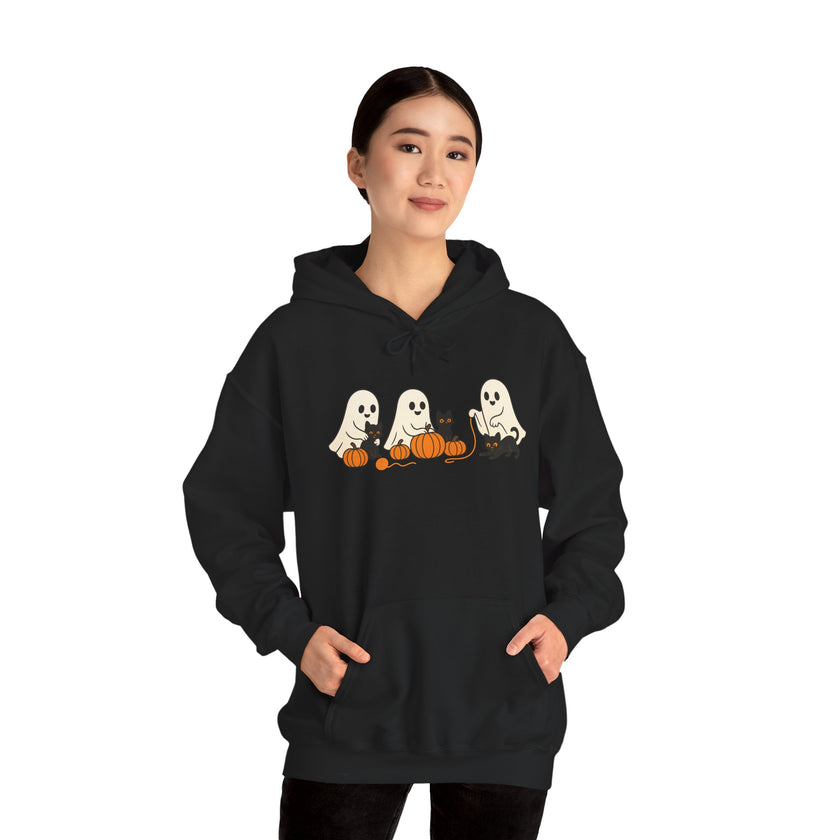Person wearing a black hoodie with Halloween-themed ghost design on a white background