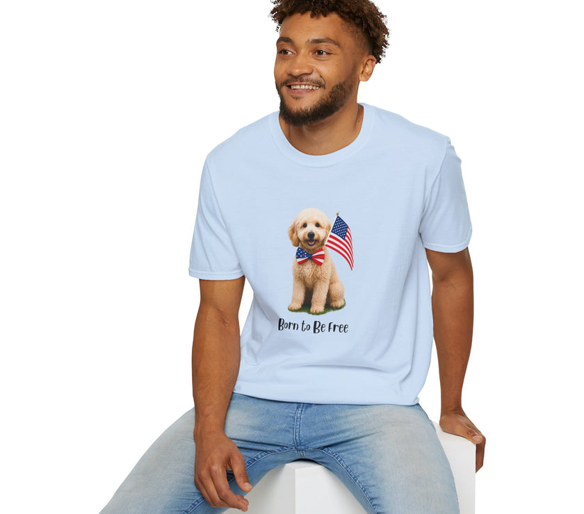 Male wearing T-shirt featuring a cute golden doodle puppy wearing an American flag bow tie and holding a small U.S. flag, with the phrase 'Born to Be Free' printed below the image.
