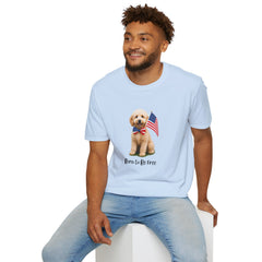 Male wearing T-shirt featuring a cute golden doodle puppy wearing an American flag bow tie and holding a small U.S. flag, with the phrase 'Born to Be Free' printed below the image.