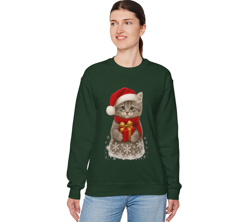 White sweatshirt featuring a gray kitten wearing a Santa hat and red scarf, holding a small red gift box with a gold bow, surrounded by snowflake designs.